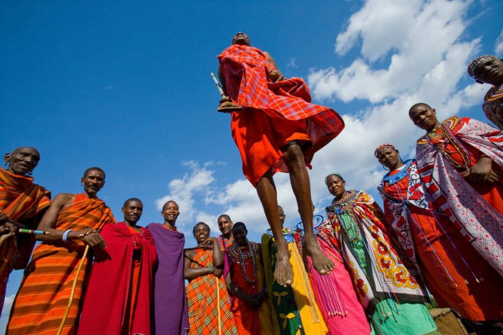 Kenya Safari Pacakages and Cultural Tours - Maasai native tribes bright clothing and jumping dance.